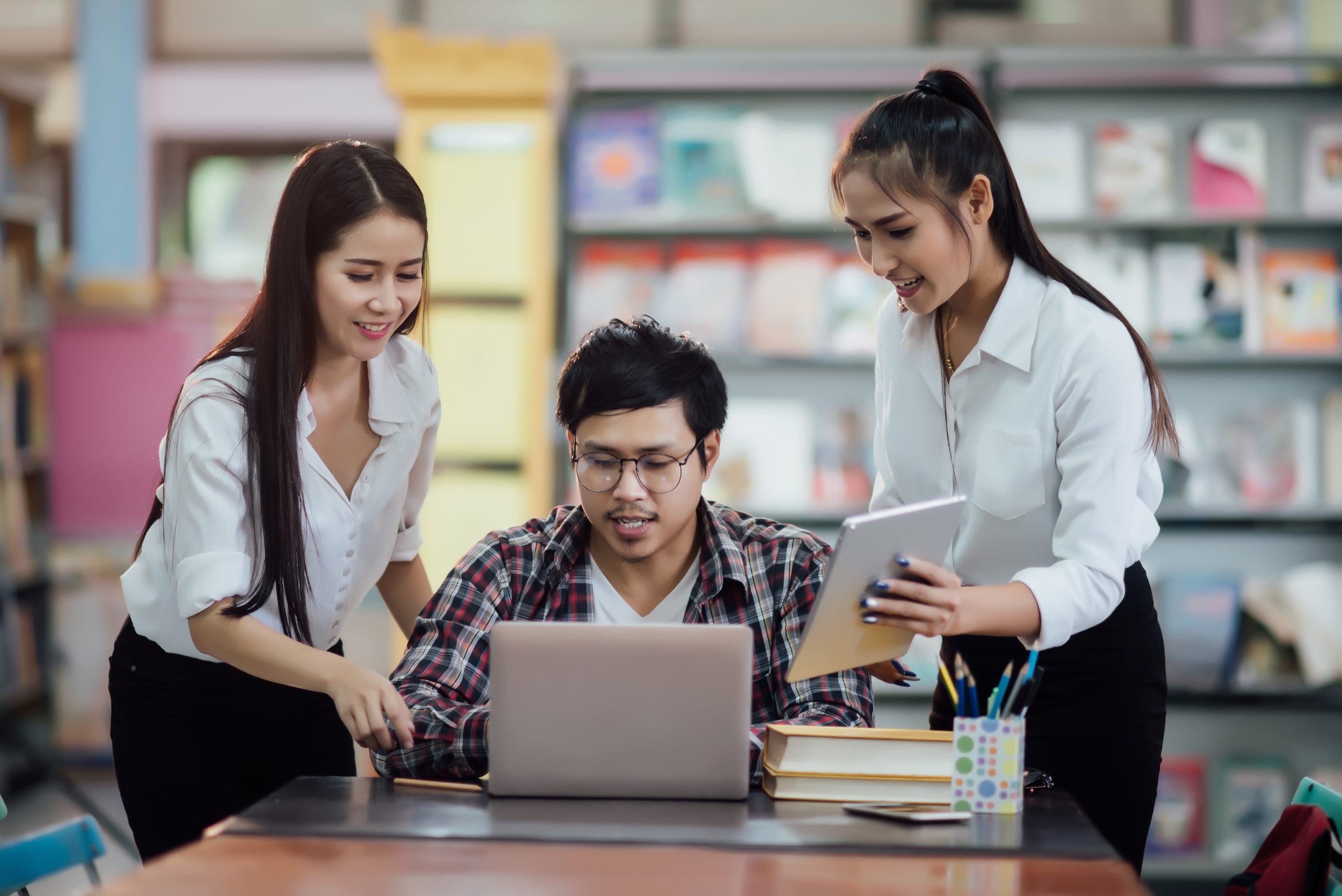 Young students learning,library bookshelves on background SNBP